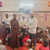 Donation handover during an indoor charity event